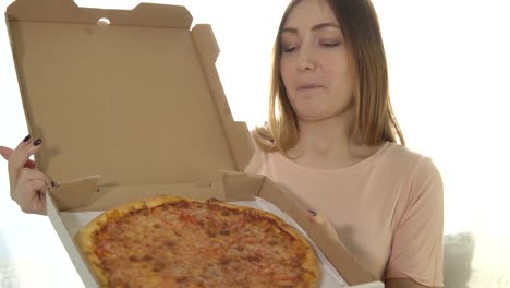 Happy-young-woman-with-hot-pizza-on-white-background.