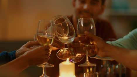 Evening-Close-up-Shot:-Man-Raises-Glass-at-the-Dinner-Table-and-Proposes-a-Toast.-Warm-Atmosphere-with-Friends-and-Family