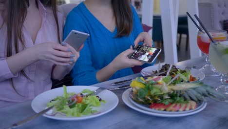 Blogging,-Hände-Freundinnen-nehmen-Bilder-von-schönen-nützlichen-Essen-auf-Handy-während-des-Frühstücks-während-Diät-zur-Gewichtsreduktion-im-café