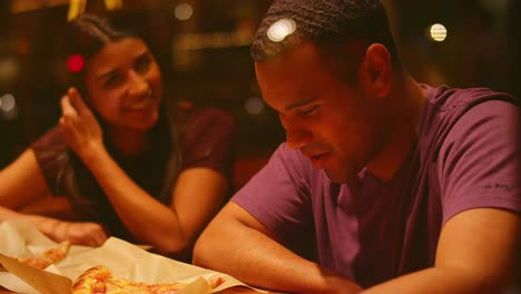 A-young-couple-eating-at-a-downtown-pizzeria