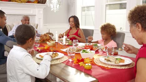 Family-Enjoying-Thanksgiving-Meal-At-Table-Shot-On-R3D