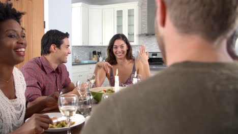 Friends-talking-and-eating-at-a-dinner-table,-slow-motion