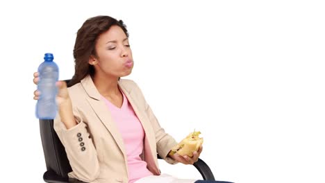 Businesswoman-eating-sandwich-for-lunch