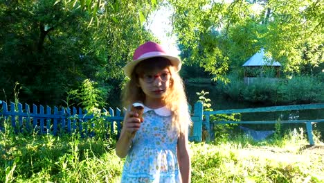 Little-girl-with-long-hair-eats-ice-cream-in-the-park.