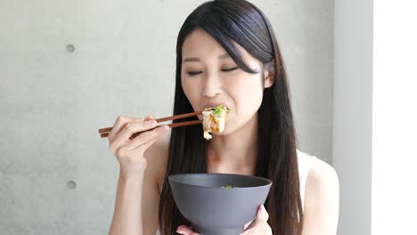 young-woman-eating-Katsudon