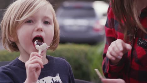 Sisters-sharing-a-cake-pop-dessert-outside