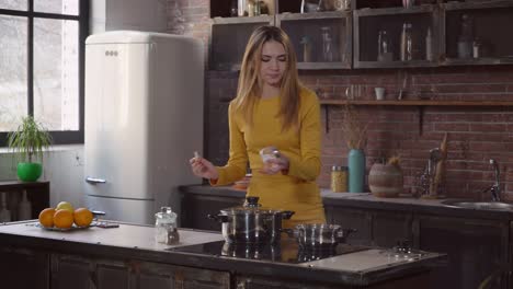 Attractive-female-cooks-lunch-with-smile-in-house