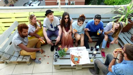 High-angle-view-of-friends-eating-pizza-on-the-rooftop-terrace