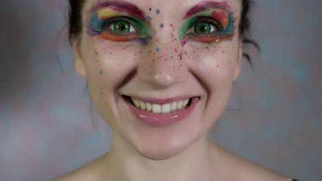 4k-Shot-of-a-Woman-with-Multicoloured-Make-up-Eating-Gooseberry