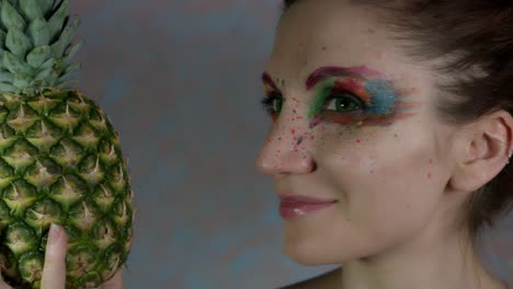 4k-Shot-of-a-Woman-with-Multicoloured-Make-up-with-Pineapple