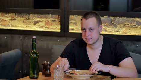 Handsome-guy-eating-a-tasty-dish-in-a-stylish-bar