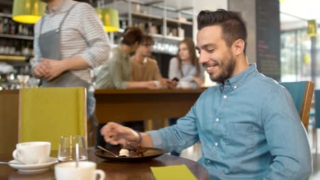 Waiter-bringing-Ice-Cream-Dessert-for-Handsome-Young-Man-at-Restaurant.