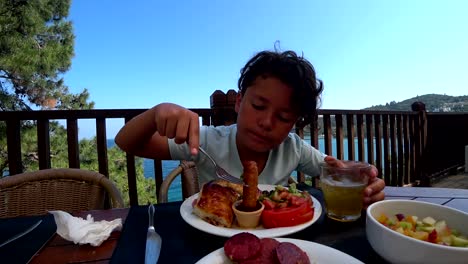 Handsome-preteen-eating-breakfast-at-the-outdoor