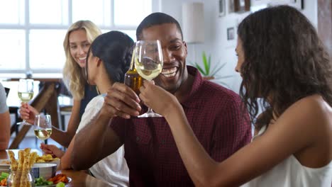 Group-Of-Friends-Enjoying-Dinner-Party-At-Home-Together