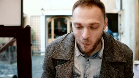 Young-handsome-man-sitting-at-the-table-in-cafe-and-enjoying-the-meal.-Hungry-male-eating-tasty-pasta-in-restaurant