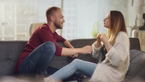 Cheerful-couple-at-home-on-couch