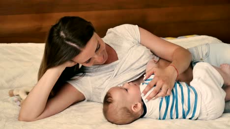 Portrait-of-young-mother-breastfeeding-her-baby-at-the-bed