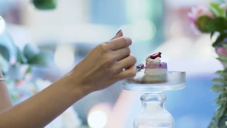 Female's-hand-takes-a-piece-of-berry-cake