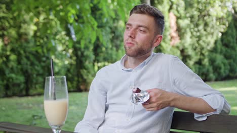 Young-Man-Having-a-Snack-in-the-Park