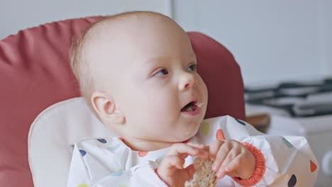 A-Baby-Girl-Eating-Bread-at-Home