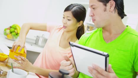 Asian-Chinese-couple-wireless-tablet-and-fresh-juice