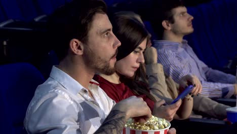 Four-friends-are-sitting-in-the-cinema-hall-and-watching-the-movie