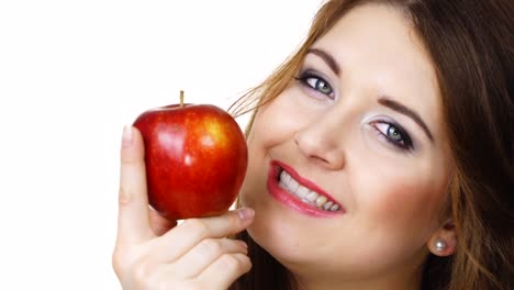 Woman-holds-apple-fruit-close-to-face