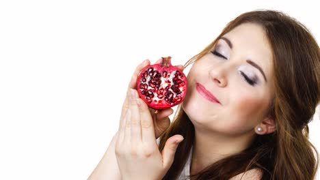 Woman-holds-half-of-pomegranate-fruit,-isolated