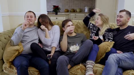 Friends-throwing-popcorn-during-watching-movie-at-home