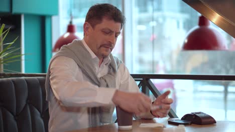 Adult-man-in-a-white-shirt-adds-sugar-to-the-fresh-made-morning-coffee