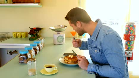 Man-using-mobile-phone-while-having-breakfast-4k