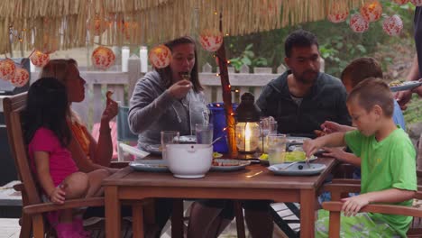 Group-of-people-eating-outdoors-in-summer.