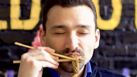 Handsome-man-tries-tasty-squid-in-batter