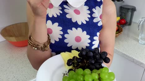 Woman-eats-apple-cloves-and-grapes.Vegetarian-concept