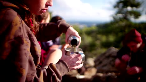 Camper-friends-having-a-coffee-and-lunch-break-on-mountain