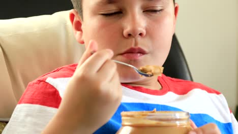 Young-boy-eating-peanut-butter