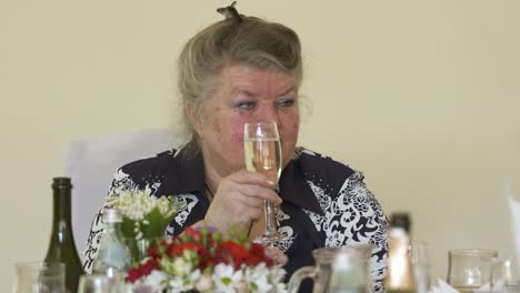 Senior-woman-at-festive-dinner-table.-Seniors-celebrating-70th-birthday