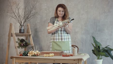 Redhead-woman-arranging-edible-bouquet-at-workplace