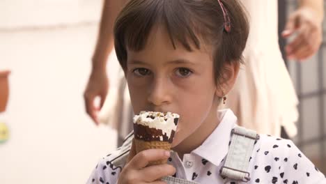 Fröhliches-fröhliches-junges-Mädchen-Daumen-hoch-beim-Essen-Eis-cornetto