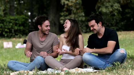 YoungFriends-At-A-Picnic-Eating-And-Talking.-Carefree,happiness,joy