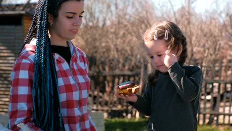 Mamá-alimenta-sándwich-de-su-pequeña-hija.