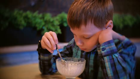 Boy-eats-ice-cream-and-watches-TV.