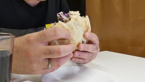 The-man-eats-kebabs-with-his-hands