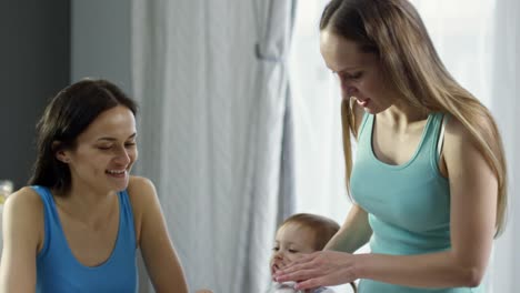 Female-Couple-with-Child-Having-Breakfast