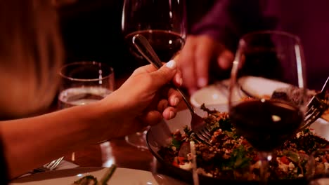 Primer-plano-de-gente-comiendo-ensalada-de-quinoa-gourmet-en-restaurante-de-lujo