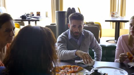 Diverse-happy-friends-eating-italian-pizza-together.