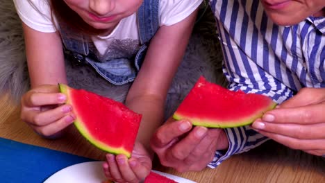 Mother-and-daughter-eat-watermelon