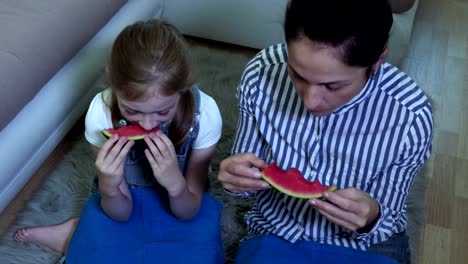 Family-eating-watermelon-on-floor