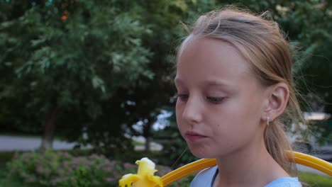 Close-up-girl-teenager-eating-ice-cream-and-licking-lips-in-summer-park