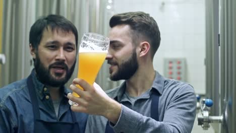 Cheerful-Brewery-Workers-Discussing-Fresh-Beer